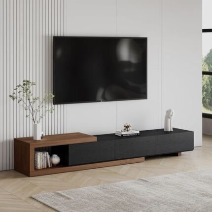 Modern TV console with a minimalist design, featuring a black and wooden finish, placed against a white wall with a mounted flat-screen TV above it.